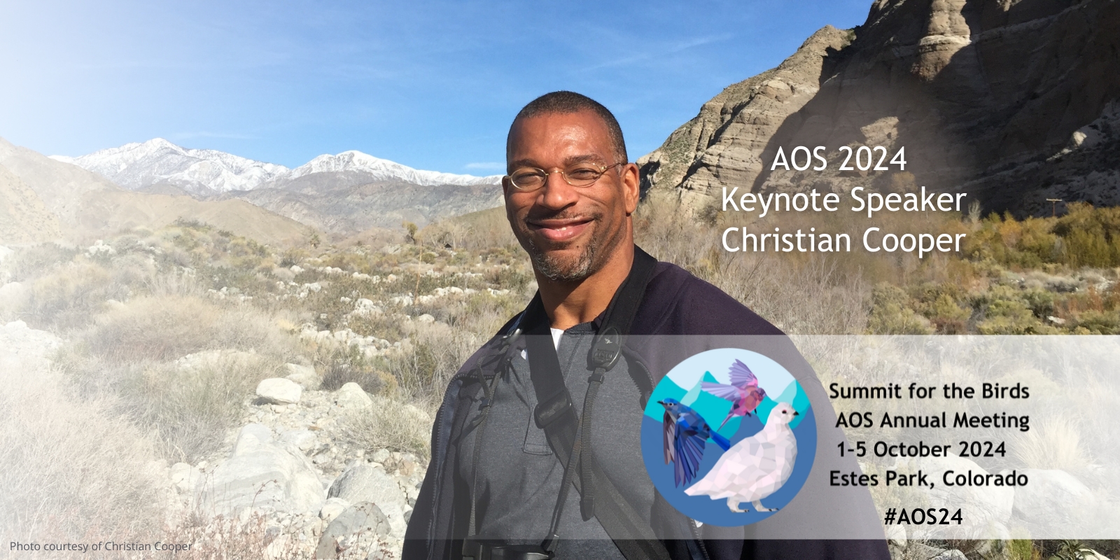 Christian Cooper stands in front of mountain